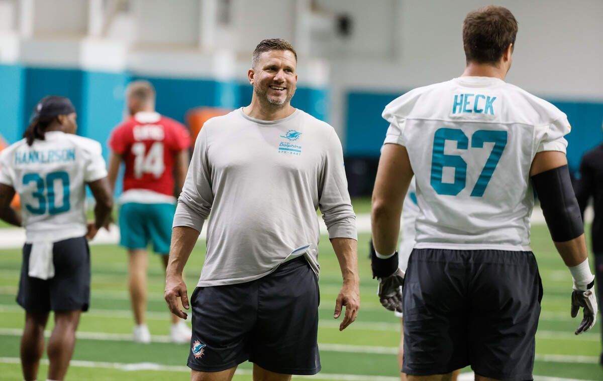 Miami Dolphins offensive coordinator Bobby Slowik speaks with tackle Charlie Heck before practice at the Miami Dolphins Training Camp in Miami Gardens, Florida, on Friday, July 31, 2026.